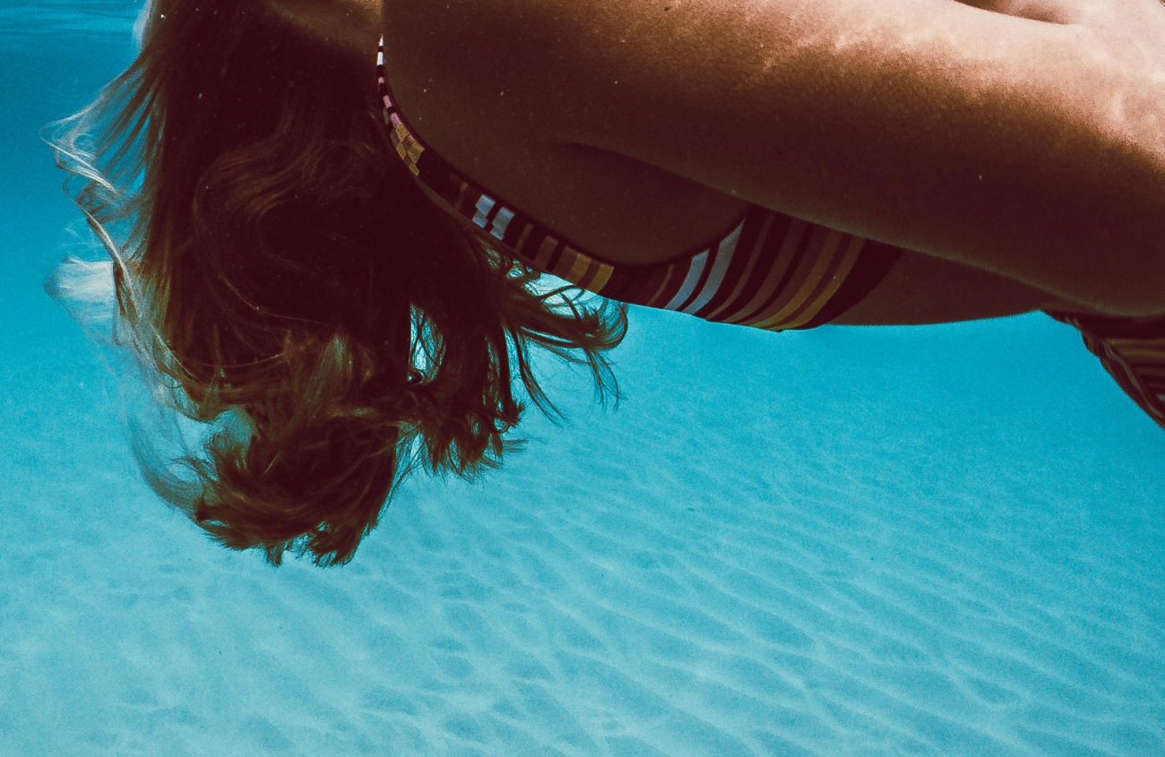  A person floating in a natural ocean landscape, symbolizing a project's purpose and emotional impact.