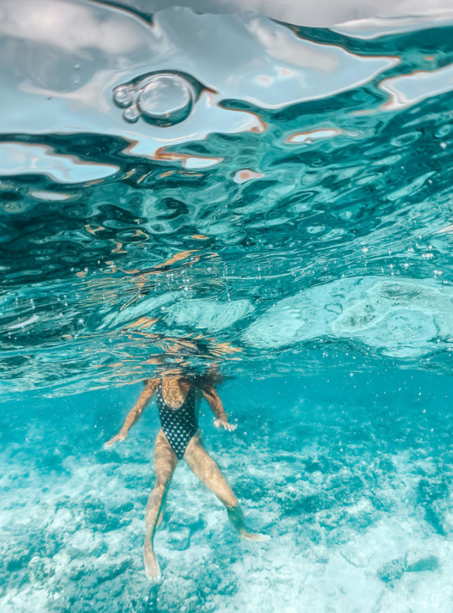 An image of someone swimming in the deep blue sea, visually representing the concept of a deep dive discovery.